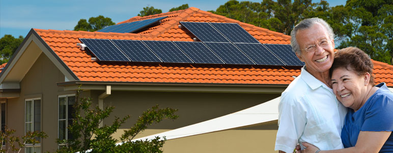 Couple in front of home with solar panels